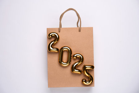 Happy New Year 2025 shopping. Shopping bag with 2025 numbers. Advertising, promotion, saleの写真素材
