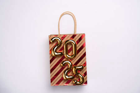 Happy New Year 2025 shopping. Shopping bag with 2025 numbers. Advertising, promotion, sale