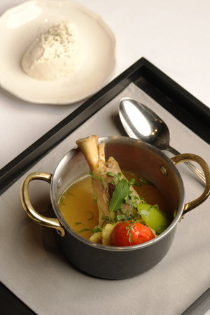 Close-up of a rustic stew with meat and vegetables in a metal pot