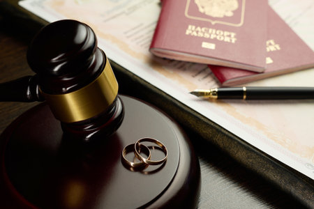 Judge gavel, legal document divorce decree, two golden wedding rings, passports and a fountain pen. Legal dissolution of a marriage with international aspects, such as divided assets or relocationの写真素材