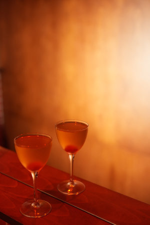 Classic cocktail glass with cherry in a nightclub bar counter, close-upの写真素材
