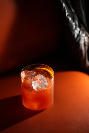 Classic orange cocktail with ice cubes served in a rocks glass nightclub restaurant, close-upの写真素材