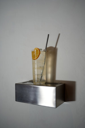 Classic Tom Collins Cocktail Glass with Lemon Slice and Strawの写真素材