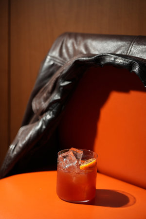 Classic orange cocktail with ice cubes served in a rocks glass nightclub restaurant, close-upの写真素材