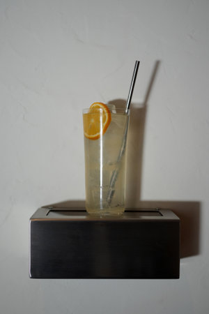 Classic Tom Collins Cocktail Glass with Lemon Slice and Strawの写真素材