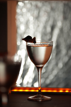Close-up cocktail glass, garnished with a piece of fried or fruit topped with a white cream and black caviarの写真素材
