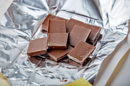 Milk chocolate pieces in a foil pack top viewの写真素材