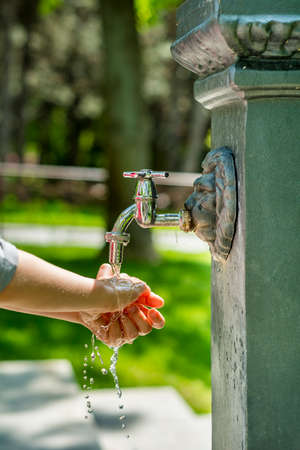 Boy washing hands outsideの写真素材