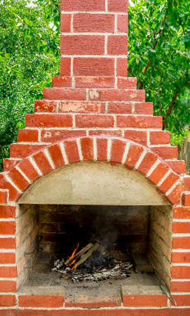 Detail of a fire burning in a brick barbecueの写真素材