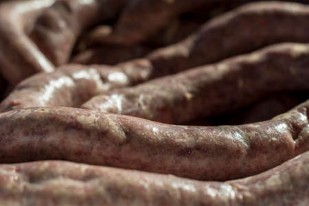 Close detail of fresh prepared raw pork meat sausagesの写真素材