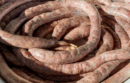 Close detail of fresh prepared raw pork meat sausagesの写真素材