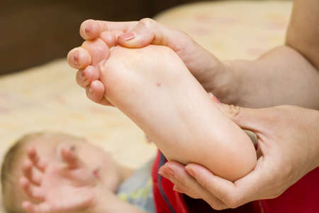 Mother looking at his son's first sign of chicken poxの写真素材