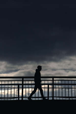 silhouette of a person standing on a pier