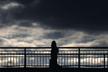 silhouette of a person on a bridgeの写真素材