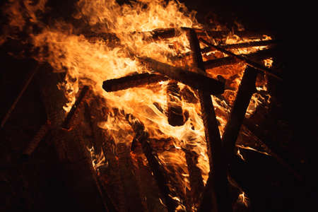 Close up of big fire with red and yellow flames in the nightの写真素材