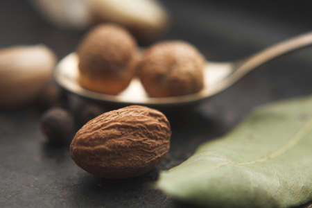 Close up image of nutmeg and spices around on dark table. Selective focusの写真素材