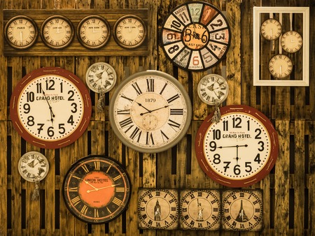Vintage clock on the brown wood texture