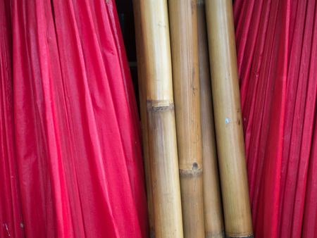 stack of red umbella and woodenbambooの写真素材