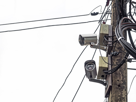 Closed circuit television on electric pole on white backgroundの写真素材