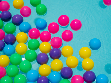 color ball floating on blue swimming poolの写真素材