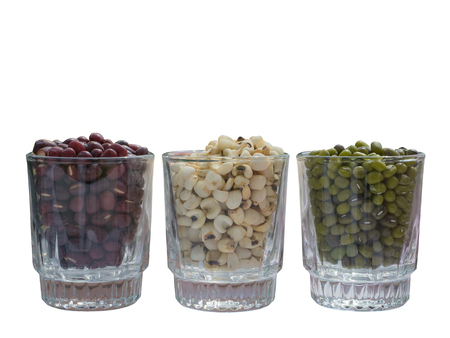Green beans, red beans and millet in glass on white backgroundの写真素材