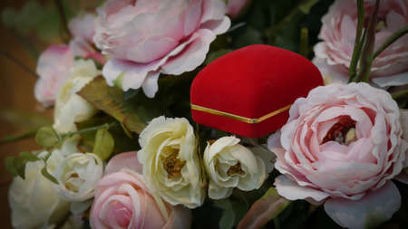 pair of wedding rings with pastel rose for background imageの写真素材