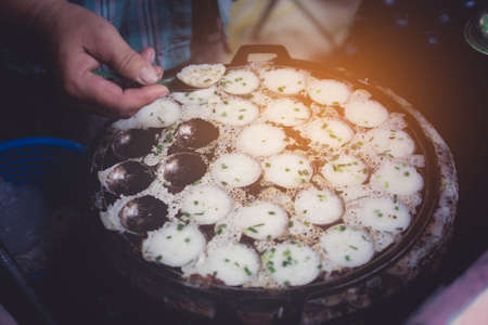 Kanom Krok ,Kind of Thai sweetmeat ,Thai dessert coconut milk mix with powder fried dessert. street food in Thailand. with vintage filterの写真素材