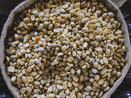 Light roast coffee beans in coffee burlap bag. top viewの写真素材