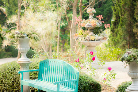 Blue garden bench in decorative outdoor garden with relaxing atmosphereの写真素材