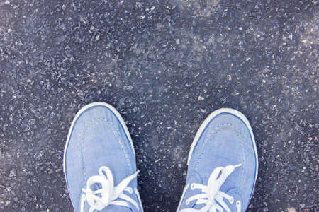 Blue sneakers on the roadの写真素材