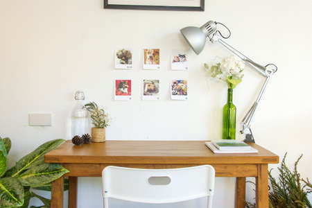 Wooden table and decorative elements in white room