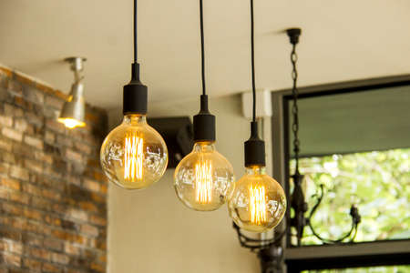 Glowing retro light bulbs hanging from ceiling