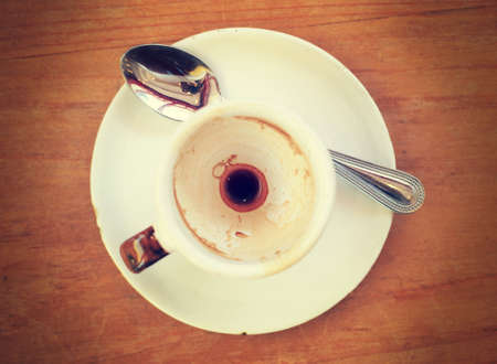 Empty Espresso coffee cup on wood table with retro filter