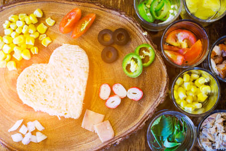 Breakfast on Valentine's day - heart-shaped bread with various ingredients for breakfast mealの写真素材