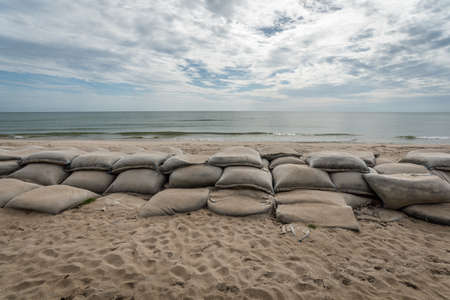 Sandbags set up as defense against erosion in Songkhla,Thailandの写真素材
