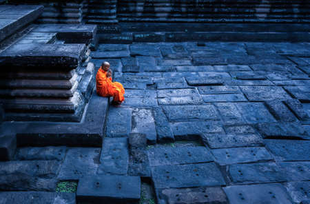 Siem Reap Cambodiai - November 22: Monk meditates at the Angkor Wat temple on 22 November  ,2014 in Siem Reap Cambodia.のeditorial素材