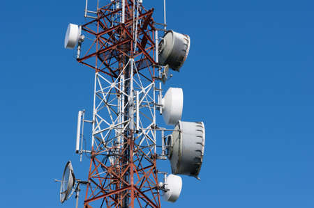 Telecommunication mast television antennas with blue sky.の写真素材