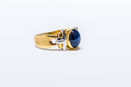 Gold ring with big sapphire on white backgroundの写真素材