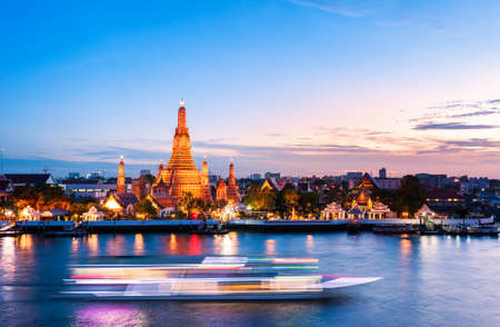 The boat was sailing in Chao Phraya River, background Wat Arun at sunset time ,Bangkok, Thailand. The Temple of Dawnのeditorial素材