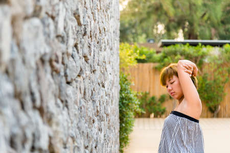 Women stretch oneself (stretch lazily) in the morning at her garden.sleep less