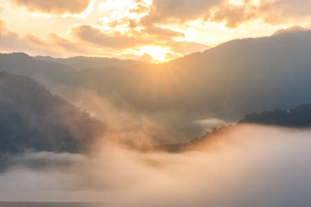 Morning fog and the beautiful sun light in a landscapeの写真素材