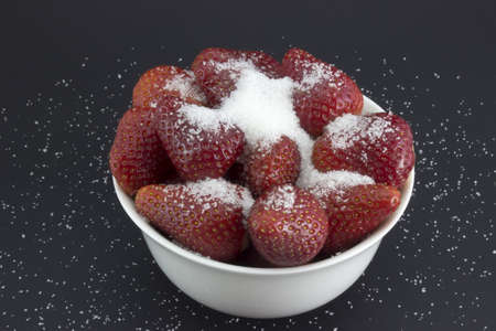 strawberries in a bowl with sugarの写真素材