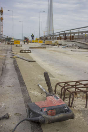 Electric drill on the construction site on construction site of Ada bridge. Focus on drill. On Sava...