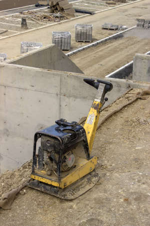 Vibrating machine for compacting soil at the construction site.