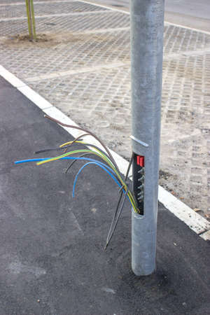 Copper wires in street light pole, small plate missing. By pulling up three or four copper wires that connect one light pole to the next, thieves can steal as much as three to four hundred yards of wire from one pole. の写真素材