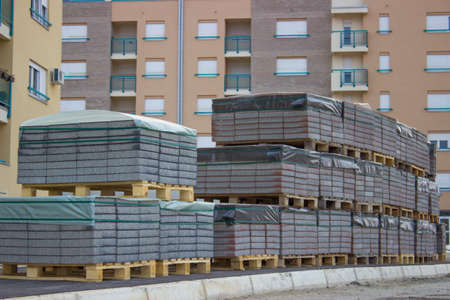 paving stones on pallets, pallets stacked at construction siteの写真素材