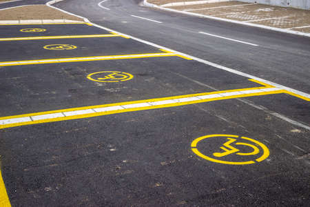 Handicap parking space just painted. Universal wheelchair symbols painted on the asphalt. Focus is...