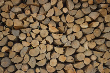firewood background - chopped firewood on a stackの写真素材