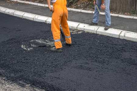 Engineer giving orders to asphalt worker during road construction
の写真素材
