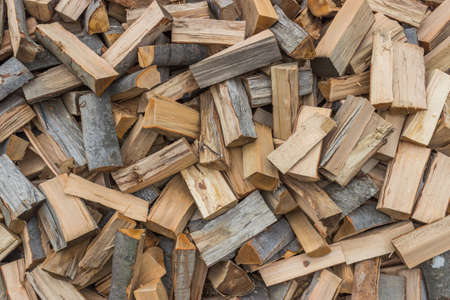 firewood background - chopped firewood on a stack